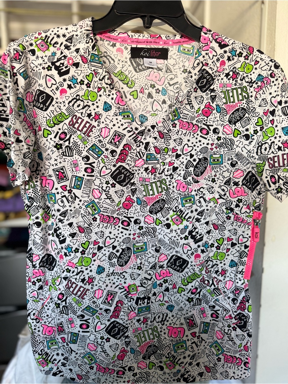 koi Women Scrub Top in White with Pink, Green, Black Accents